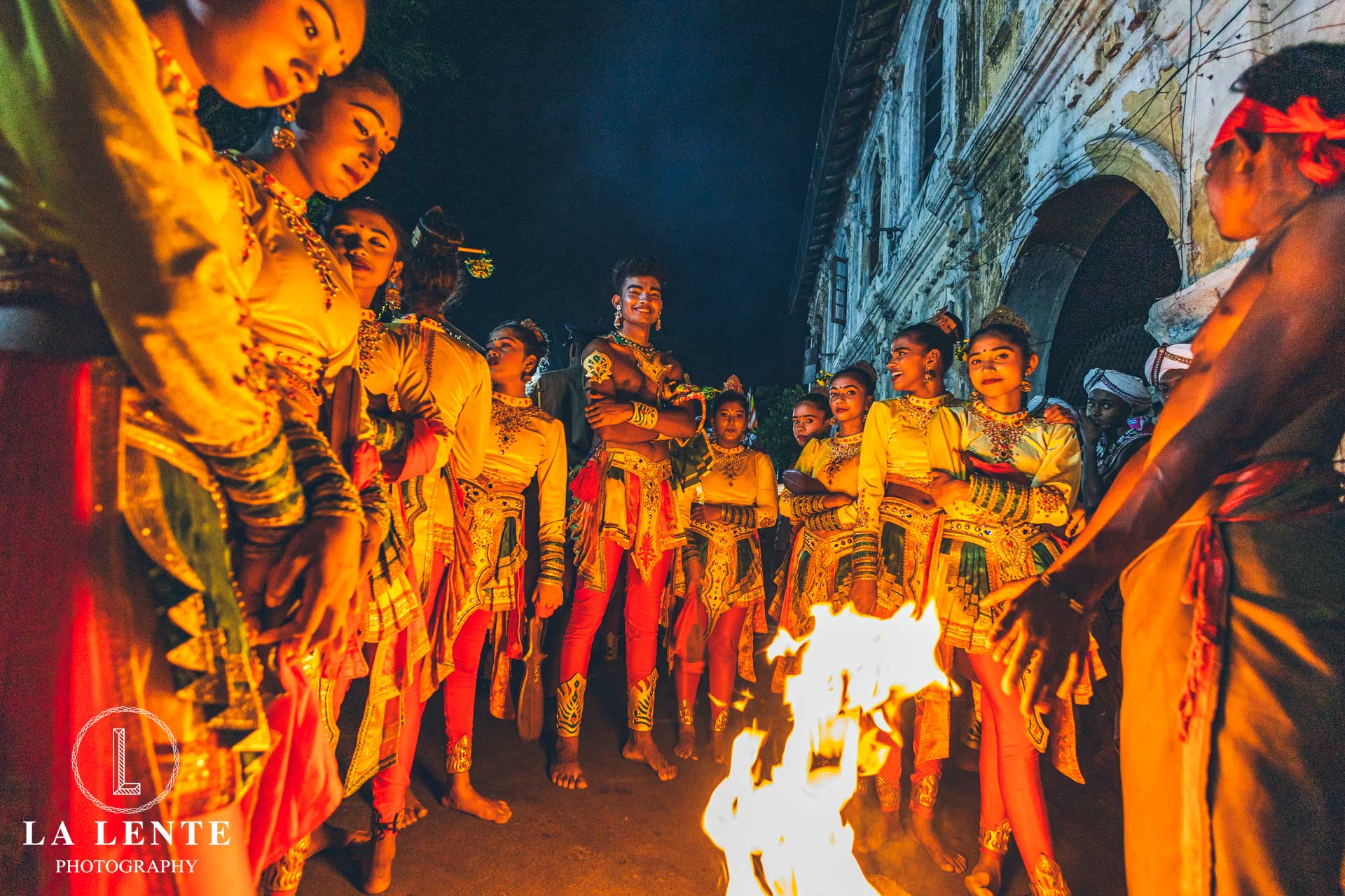 Performers keeping warm with fire at Kandy Esala Perahera in Sri Lanka